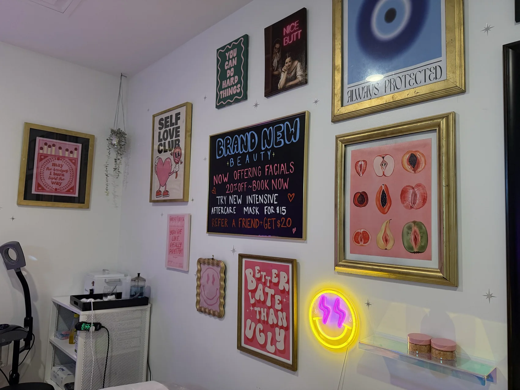 Gallery wall with the Brand New Beauty chalkboard menu and playful art