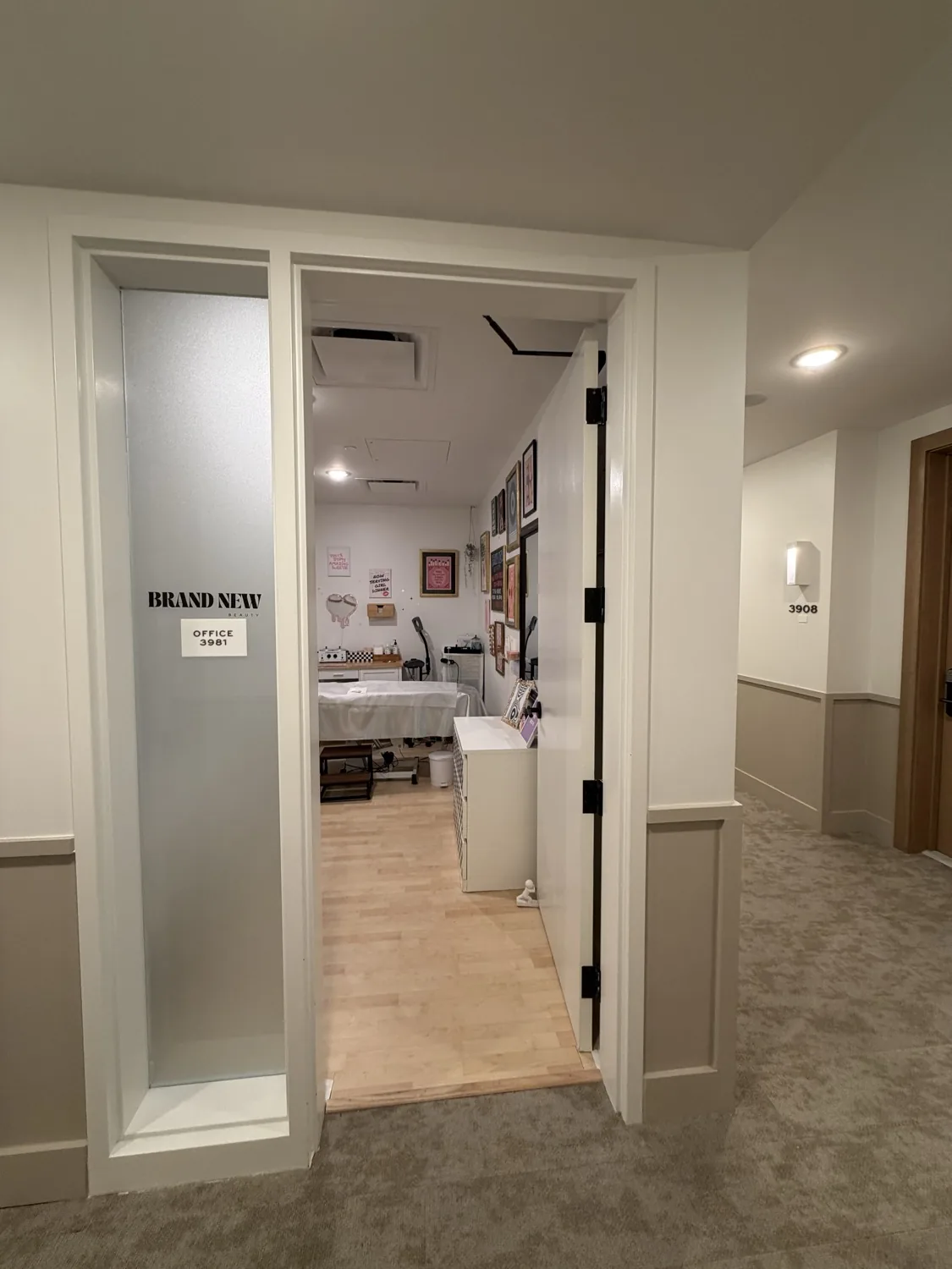 The frosted Brand New Beauty studio door opening into the private suite