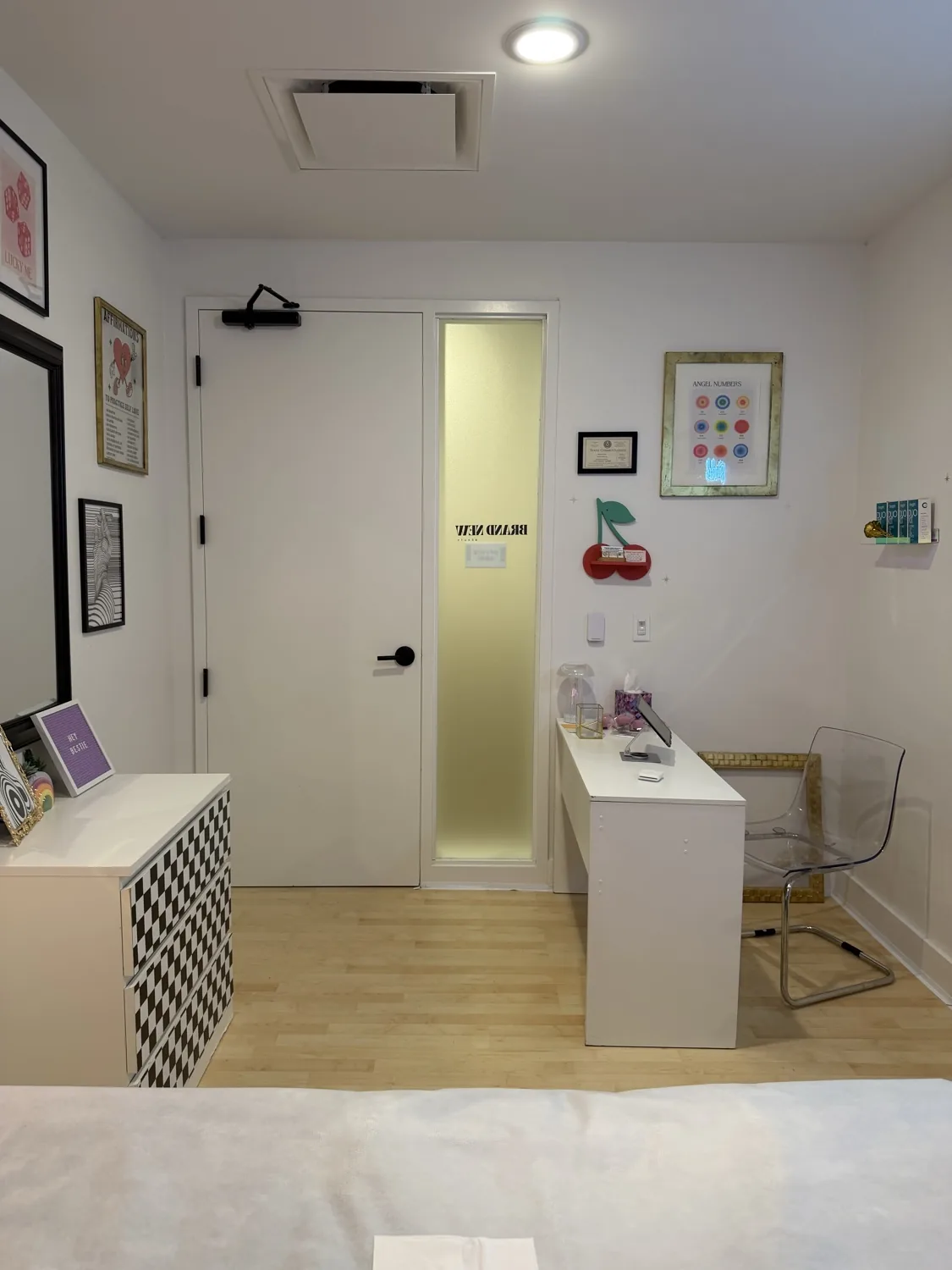 Tidy vanity station with a clear chair and cherry decor